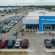 Aerial view of a Chevrolet dealership featuring new and used cars on display, customers entering the showroom, and surrounding automotive facilities visible in the background—highlighting Willowood Ventures’ automotive sales environment.