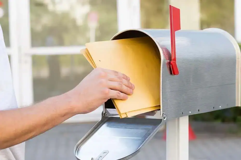 Mailbox with envelopes outside, representing automotive marketing direct mail campaigns for car dealerships.