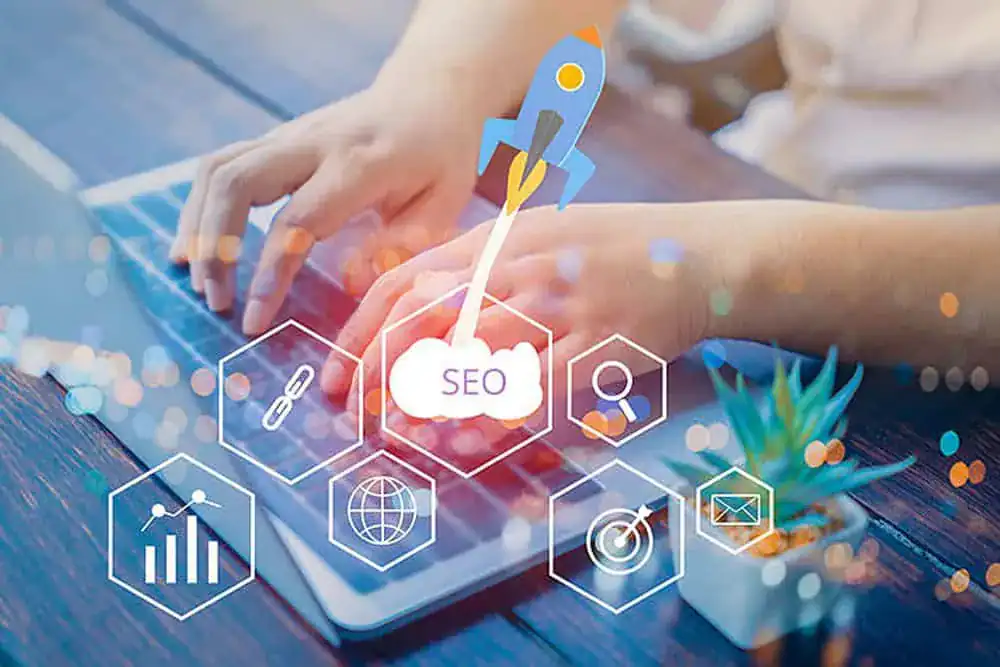 Modern digital tablet displaying SEO strategy icons with hands typing, representing automotive marketing and SEO services.