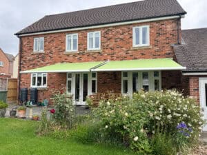 Motorised Weinor awning installed at a home in Andover creating shade over a patio seating area