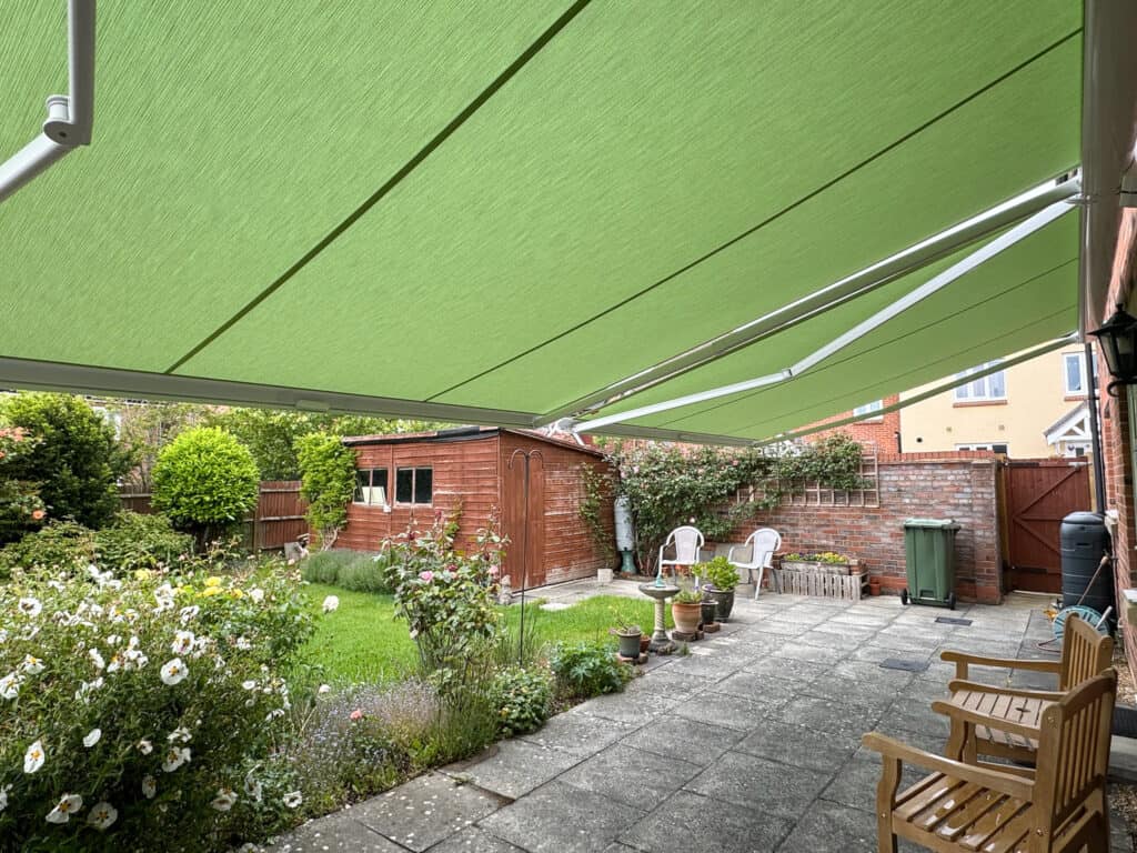 Sage green Weinor awning fabric chosen to complement a garden in Andover