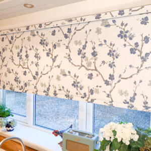 Blue floral roller blind in a kitchen window