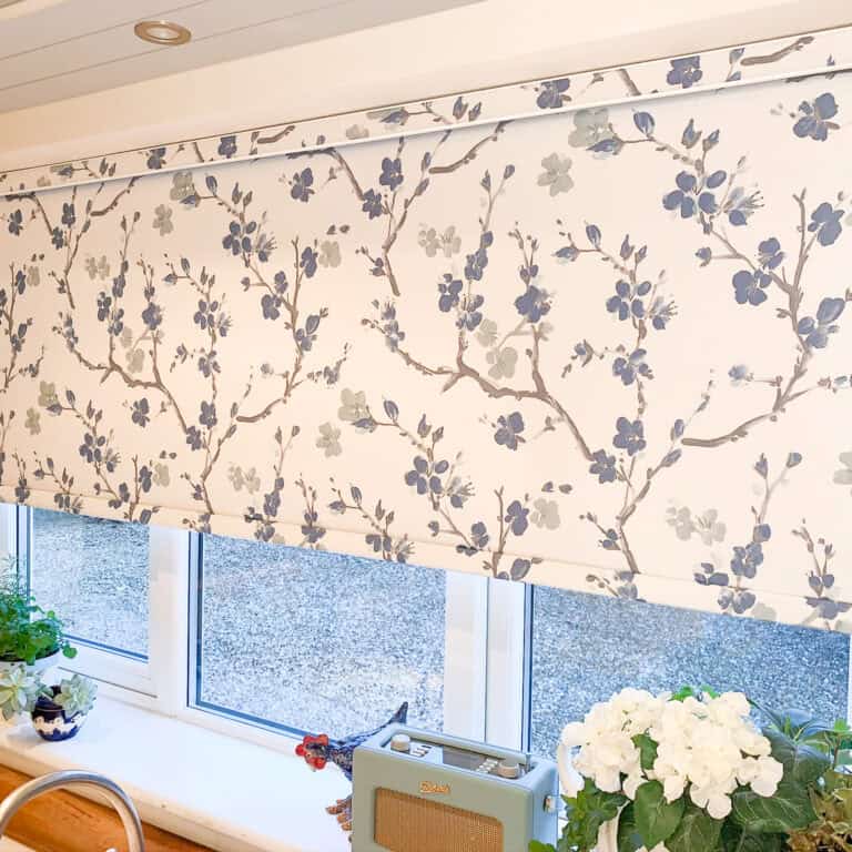 Blue floral roller blind in a kitchen window