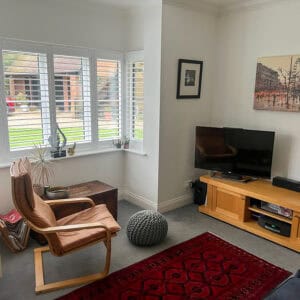 Bespoke plantation shutters following the shape of a bay window in Romsey