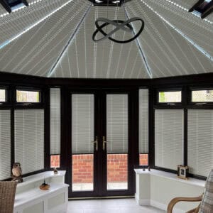 Motorised pleated conservatory roof blinds reducing heat and glare while maintaining natural light in a conservatory in Ropley Hampshire.
