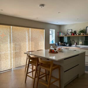 Motorised roller blinds to bifold kitchen doors to reduce summer heat and glare.