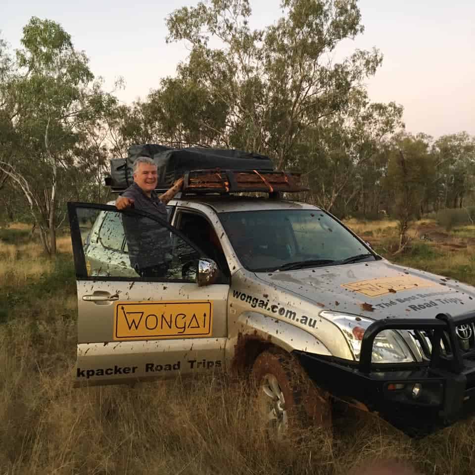 Brisbane 4wd hire with man hanging out the door looking happy