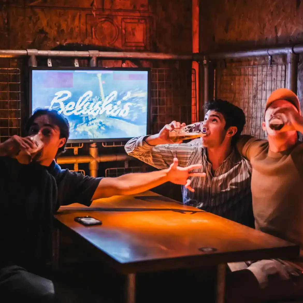 Group of friends enjoying drinks at Belushi's during the World Cup.