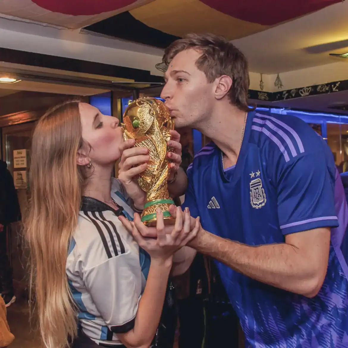 Fans celebrating with the World Cup trophy at Belushi's pub.