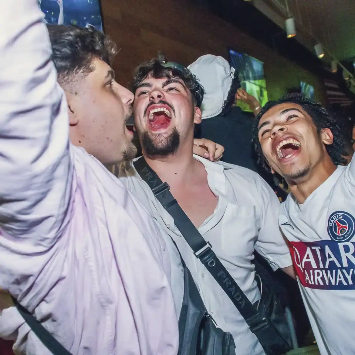 Group of friends celebrating at Belushi's during World Cup match.