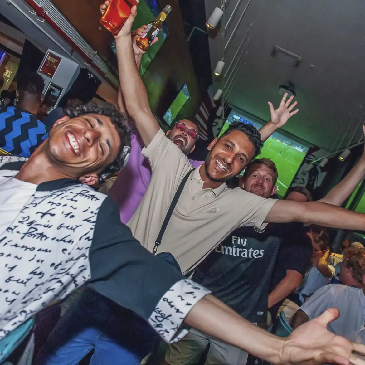 Happy fans celebrating at Belushi's during the World Cup event.