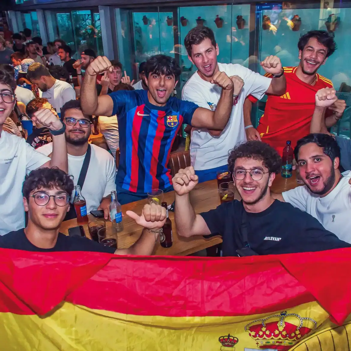 Group of football fans celebrating at Belushi's during the World Cup.