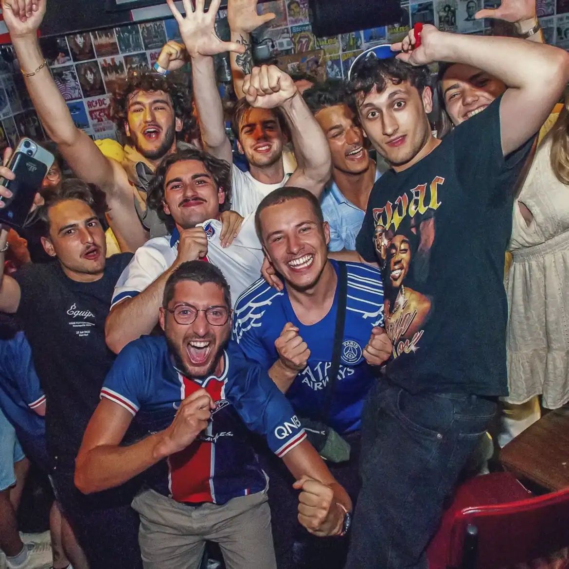Group of excited fans celebrating at Belushi's during the World Cup.