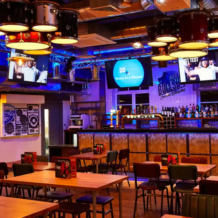 Belushi's Edinburgh sports bar interior near the Grassmarket showing projectors and seating for watching the World Cup live