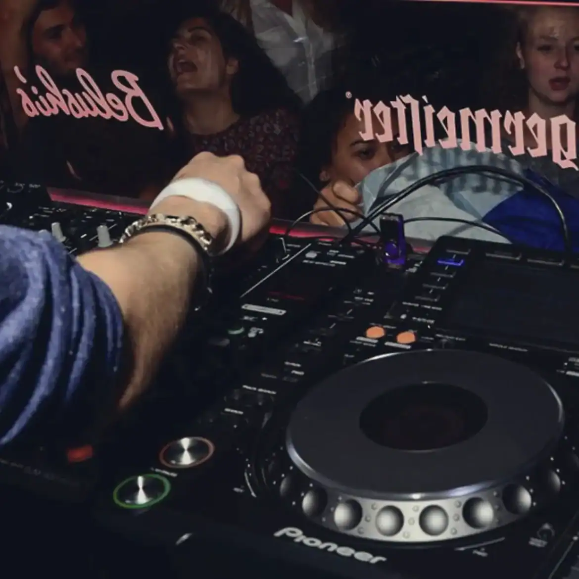 DJ playing music at Belushi's during World Cup event in Paris.