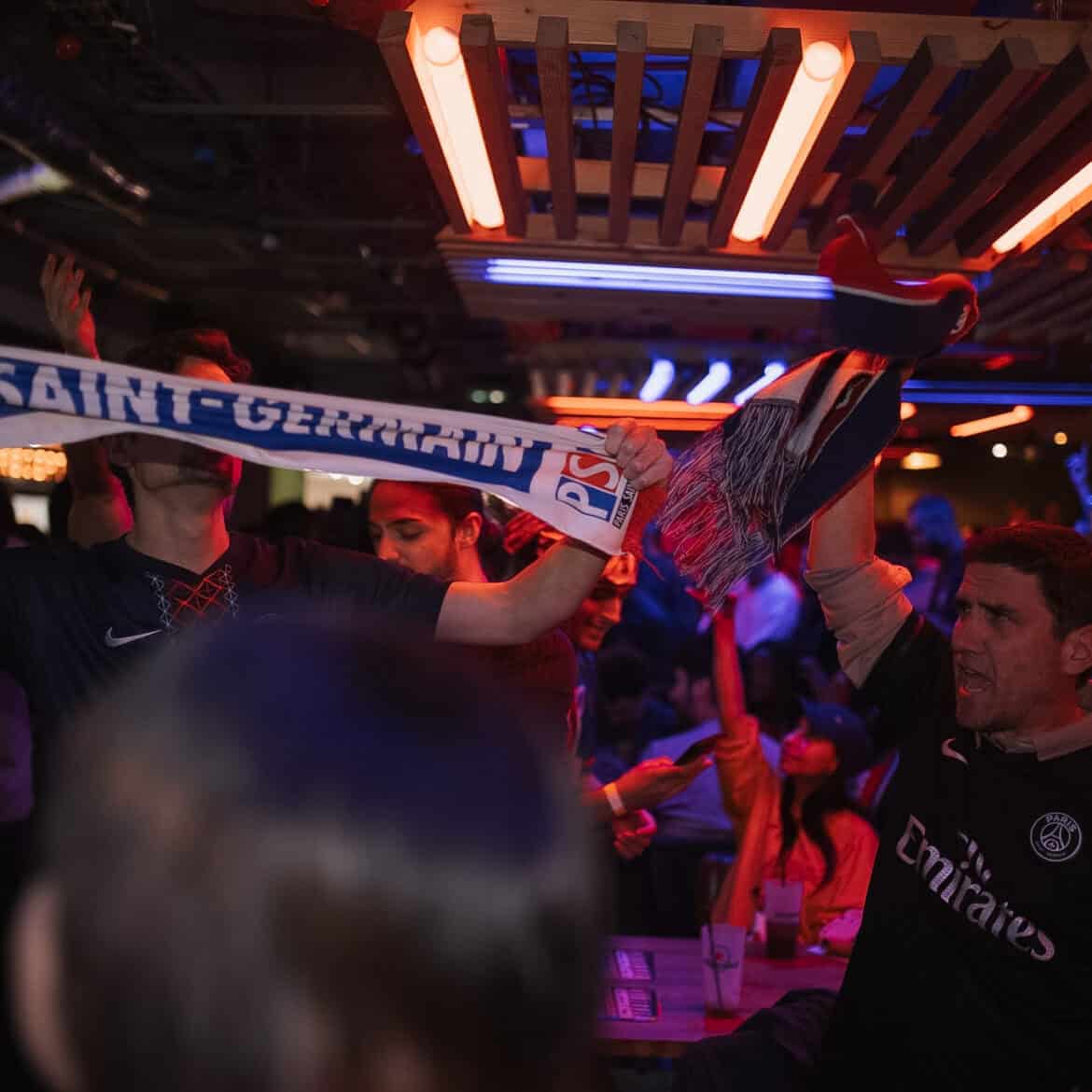 Fans celebrating at Belushi's during the World Cup event in a lively bar setting.