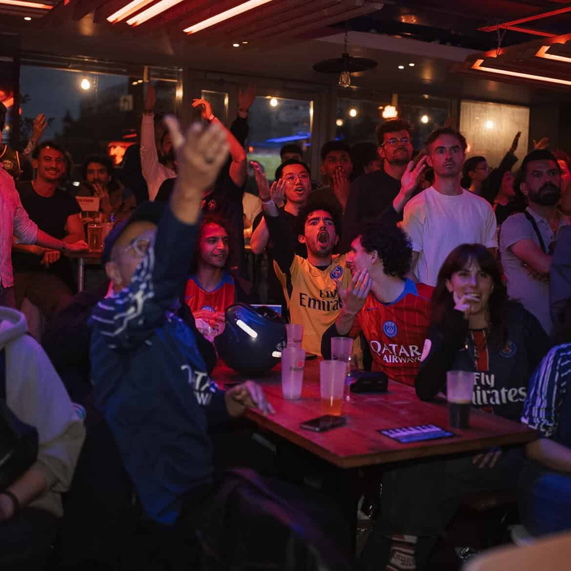 Crowd watching World Cup match at Belushi's pub in London.