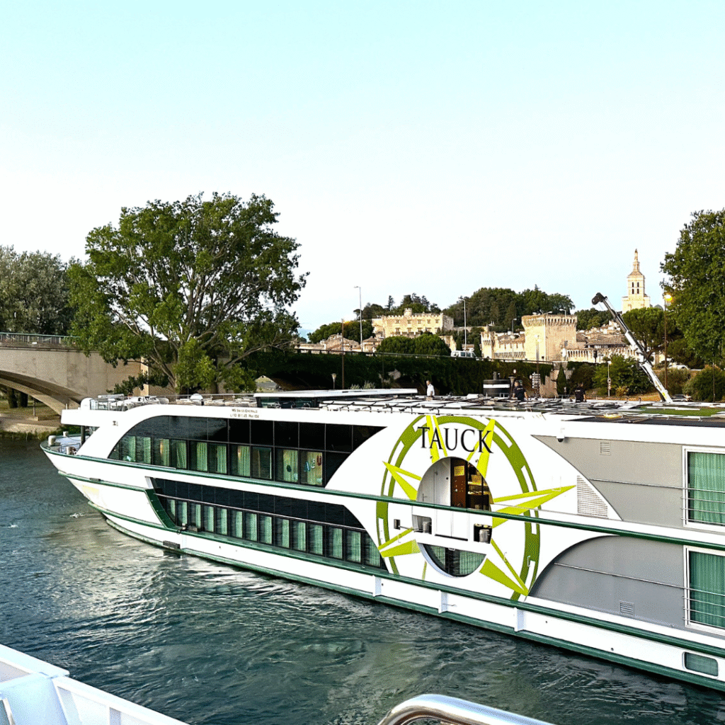 Tauck river ship docked along the Rhône River in Avignon, France, near the town’s famous medieval landmarks.