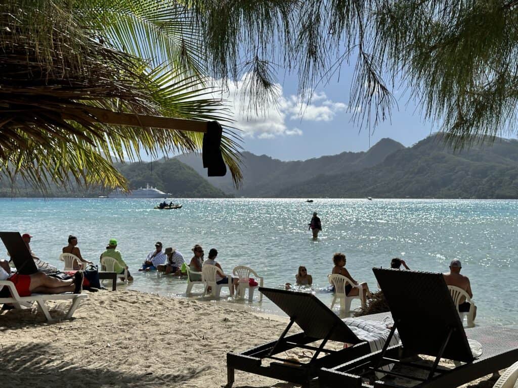Island BBQ Picnic in French Polynesia with Windstar Star Breeze in the background. Small Ship Cruise Inspiration for 2026.