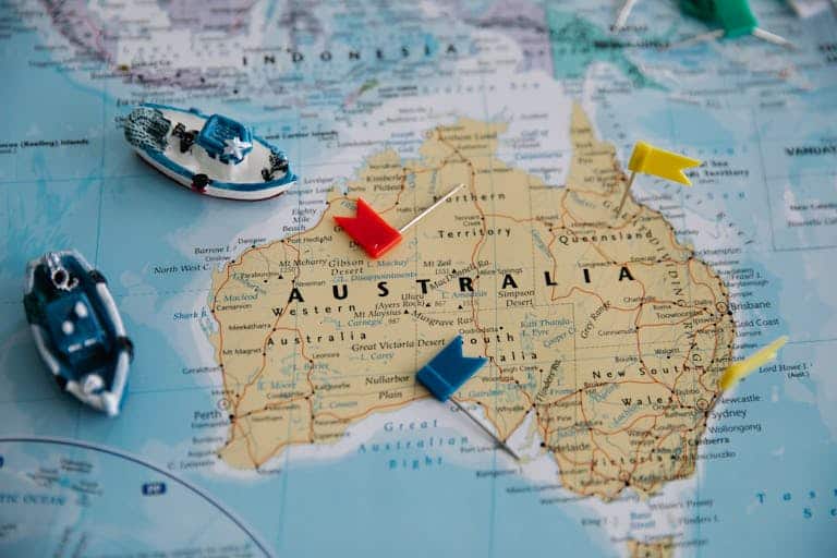 Colorful map of Australia featuring toy ships and pins for navigation. Australia Travel Tips for Americans Over 50