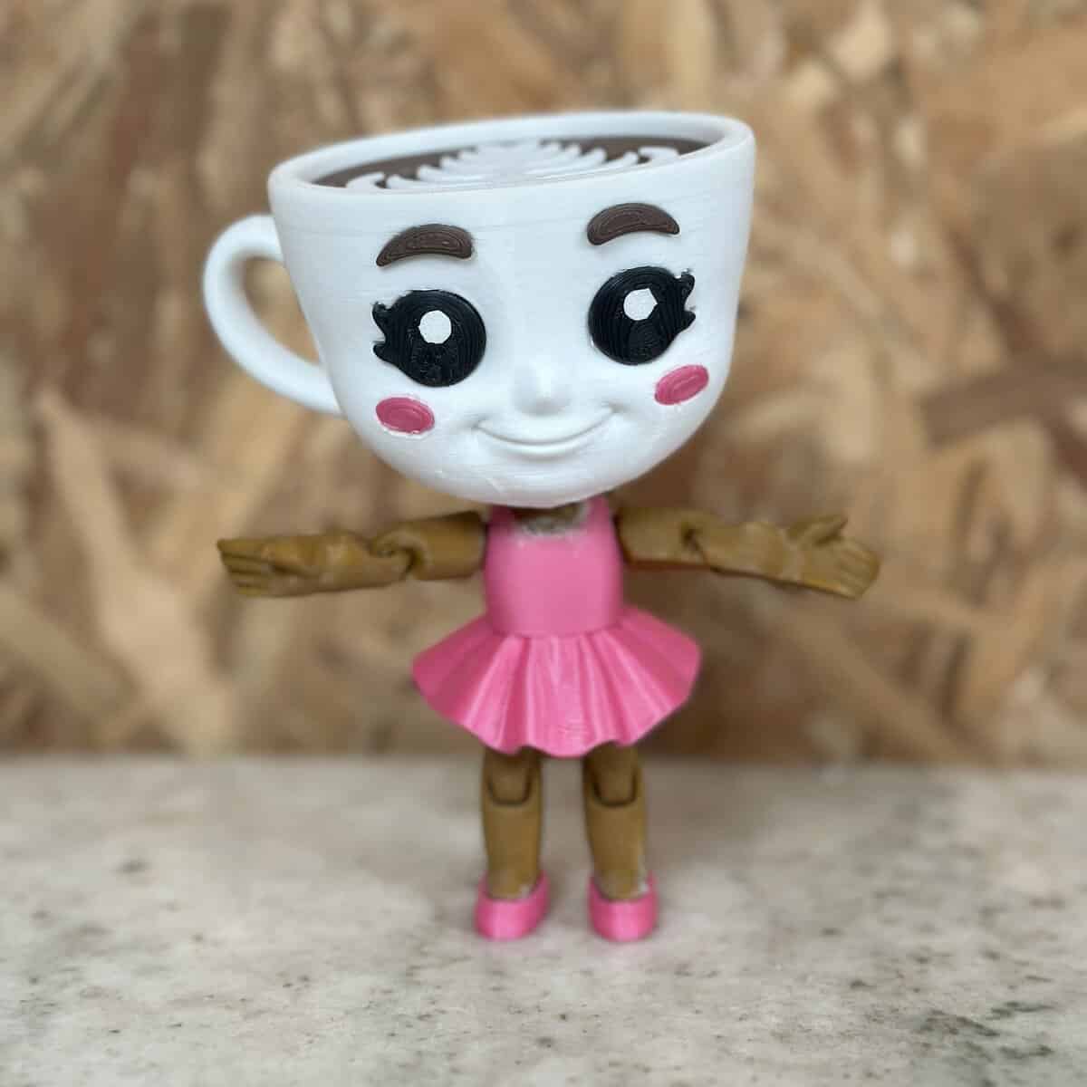 Muñeca controlador de plásticos con taza en forma de cabeza, diseño adorable, perfecta para decoración y colección, hecha en materiales plásticos duraderos.