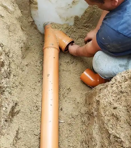 Plumber-Installing-Underground-Sewer-Drain-Pipe-Connection