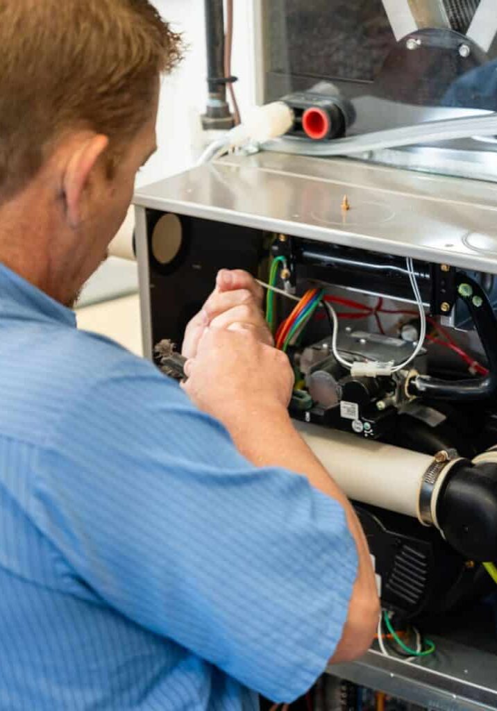 HVAC-Technician-Repairing-Furnace-Wiring-And-Internal-Parts