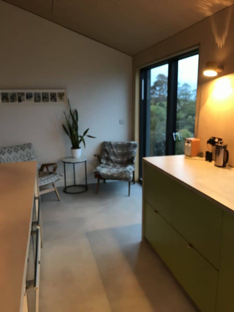 Bright modern interior with large windows, stylish furniture, and minimalist décor.