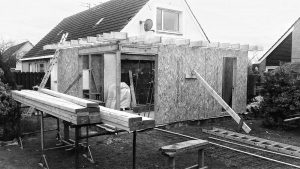 Construction of residential extension with timber framing and insulation materials.
