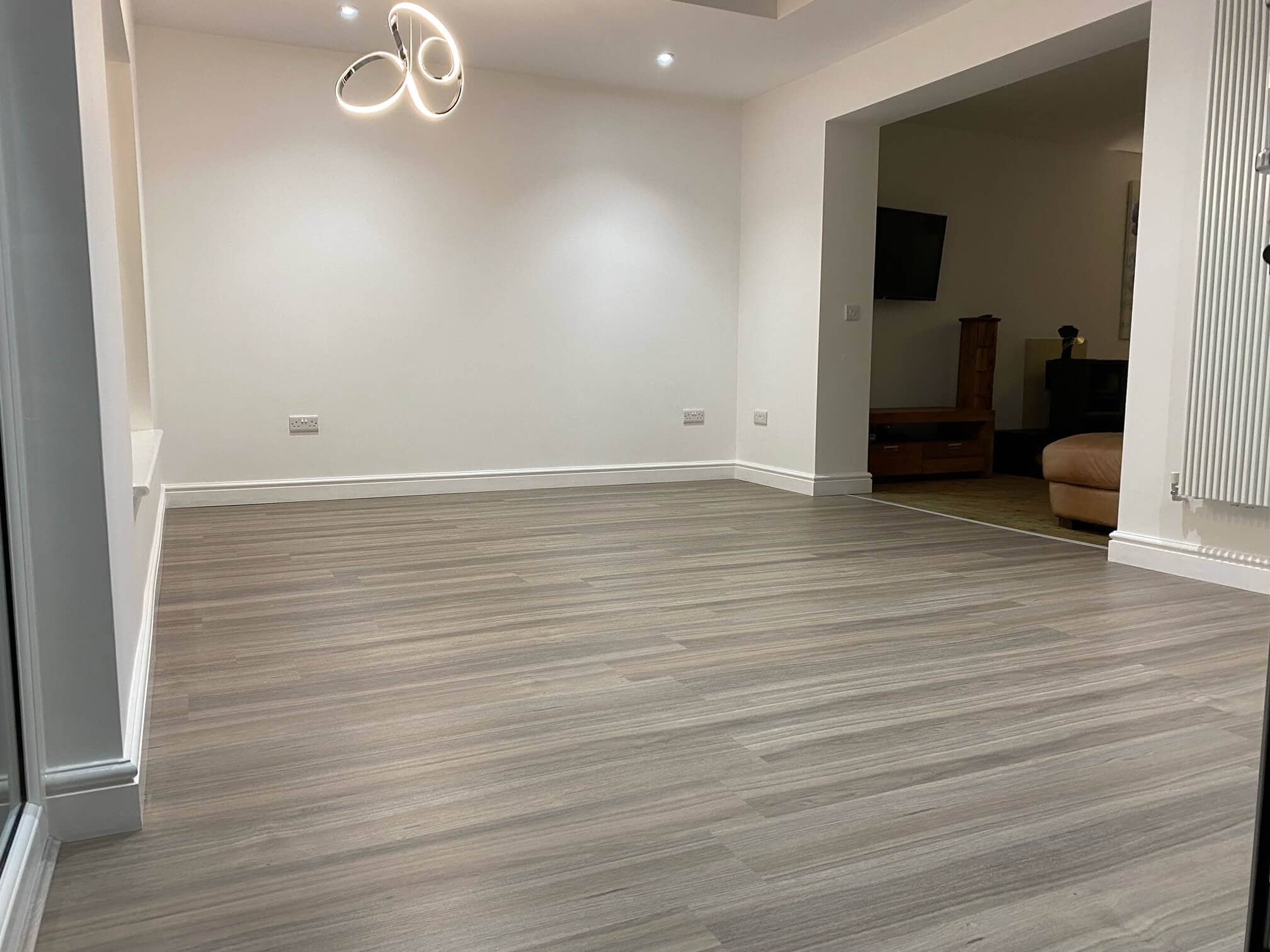 Contemporary living space featuring stylish flooring and minimalist decor, created by ABC Architecture.