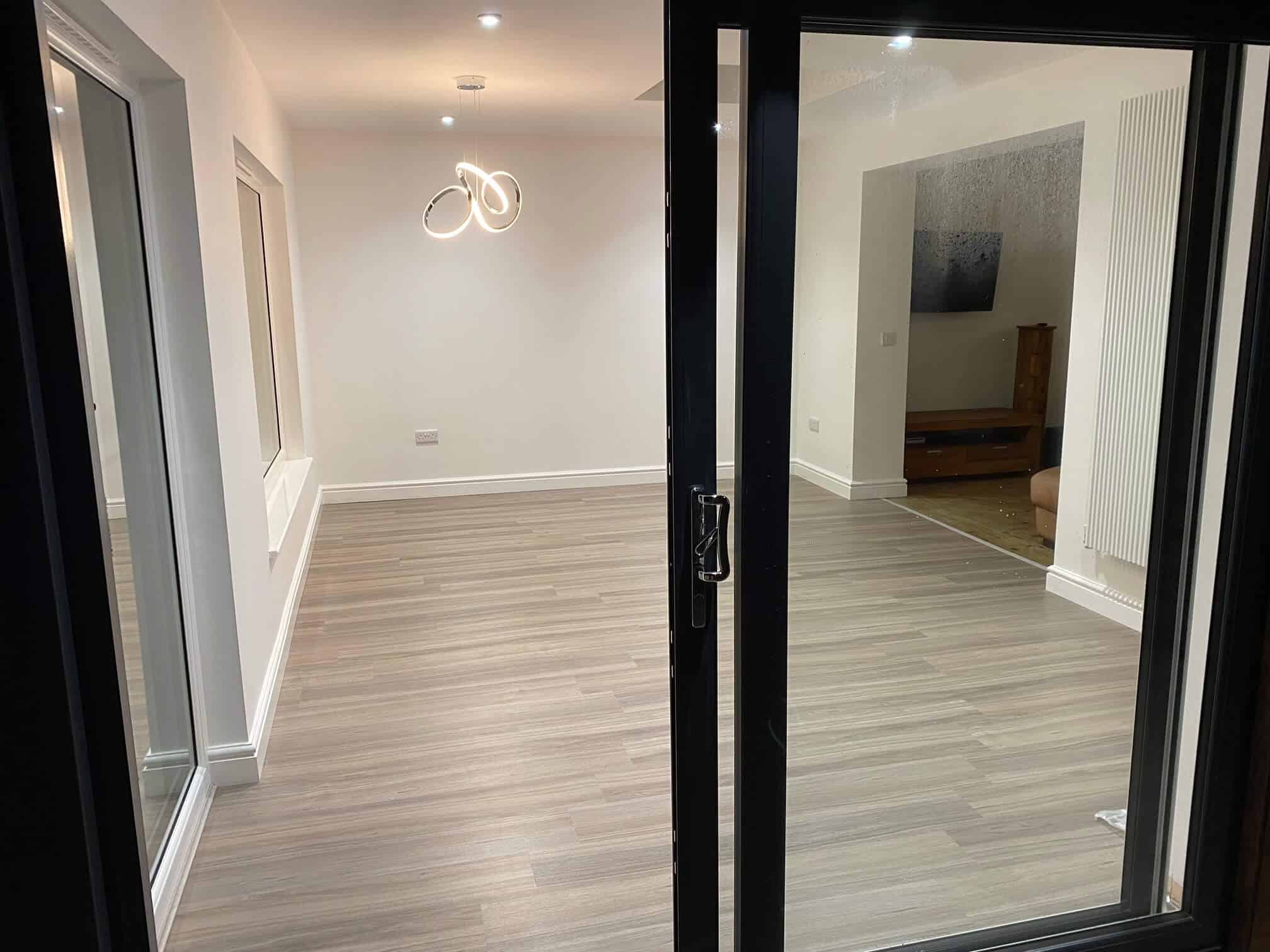 Contemporary home interior featuring spacious living areas with stylish lighting and sleek finishes.