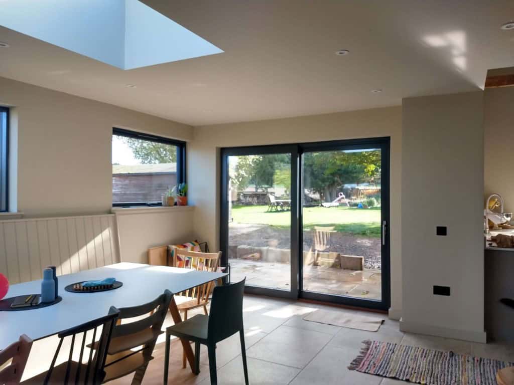 Bright interior featuring sliding glass doors opening to garden, ideal for contemporary UK homes.