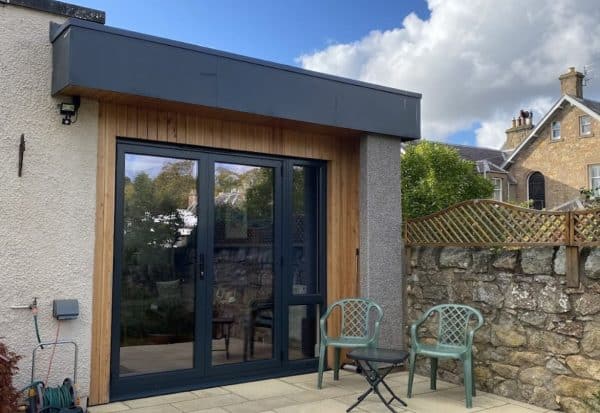 High-quality garden room with modern design, double-glazed doors, and natural wood finishing.