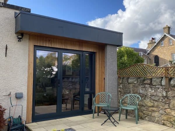 High-quality garden room with modern design, double-glazed doors, and natural wood finishing.