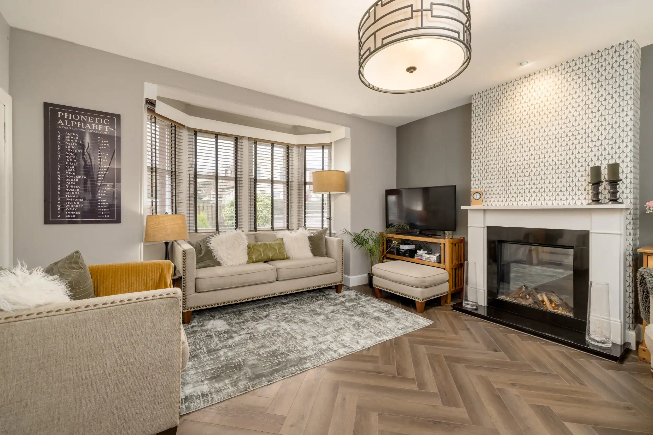 Bright and modern living room with neutral tones, cosy sofas, and stylish decor.