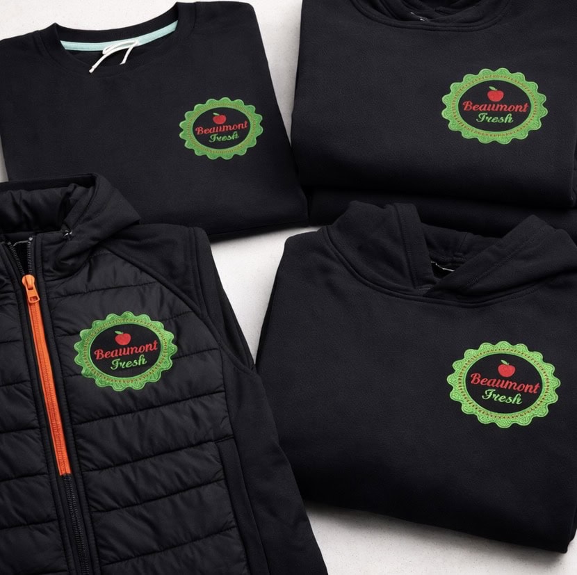 Embroidered Beaumont Fresh logo on black apparel and jackets for custom branding.