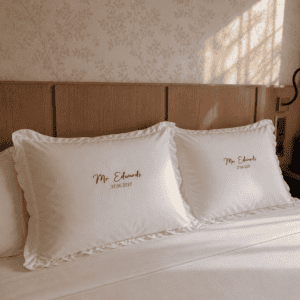 Embroidered pillowcases with custom names and dates, perfect for wedding decor and special occasions.