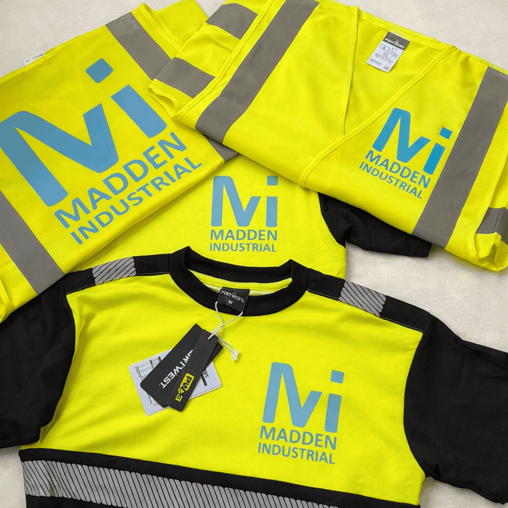 High-visibility yellow safety jackets and shirts with Madden Industrial logo for industrial work saf.