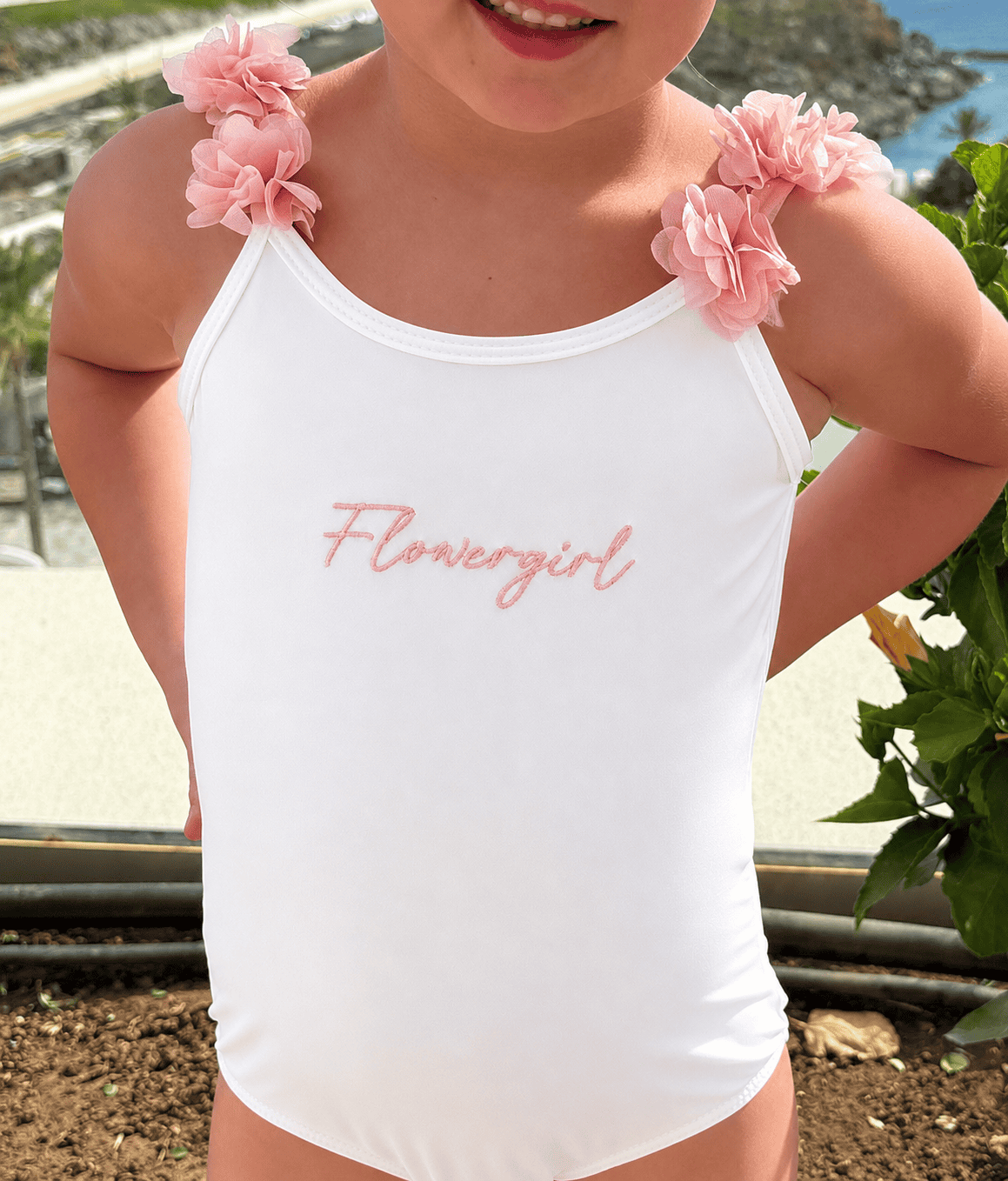Embroidered flower girl dress with pink floral shoulder details, perfect for special occasions and w.
