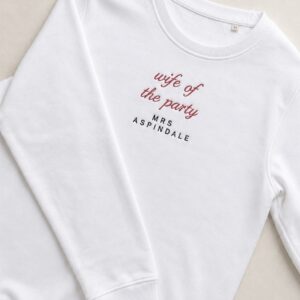 Embroidered sweatshirt with "Wife of the Party" and "Mrs. Aspindale" text, perfect for bridal or wed.