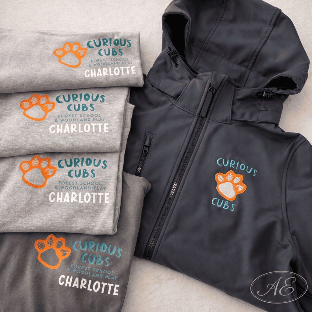Custom embroidered Curious Cubs logo on clothing for forest school and woodland play.