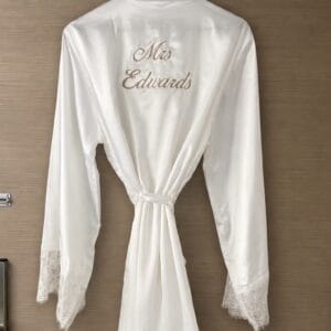 Elegant bridal dressing gown with lace cuffs, perfect for wedding preparations.