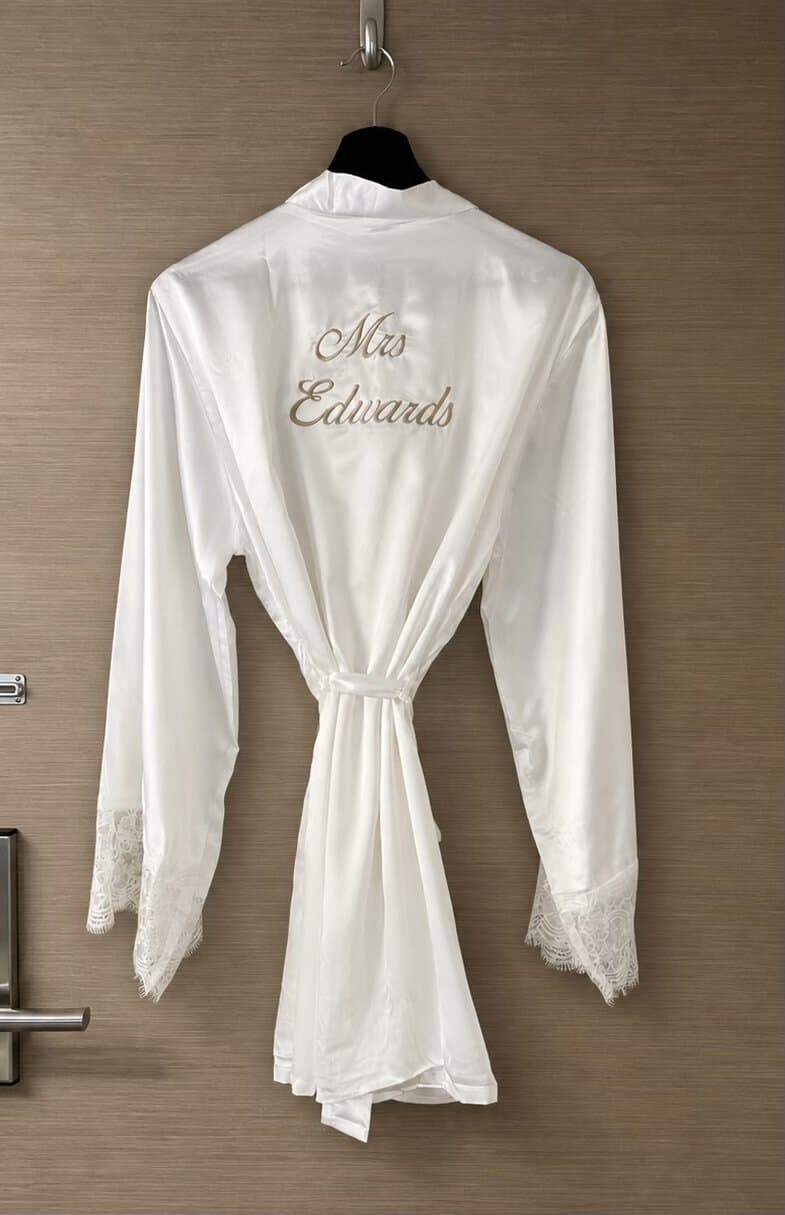 Elegant bridal dressing gown with lace cuffs, perfect for wedding preparations.
