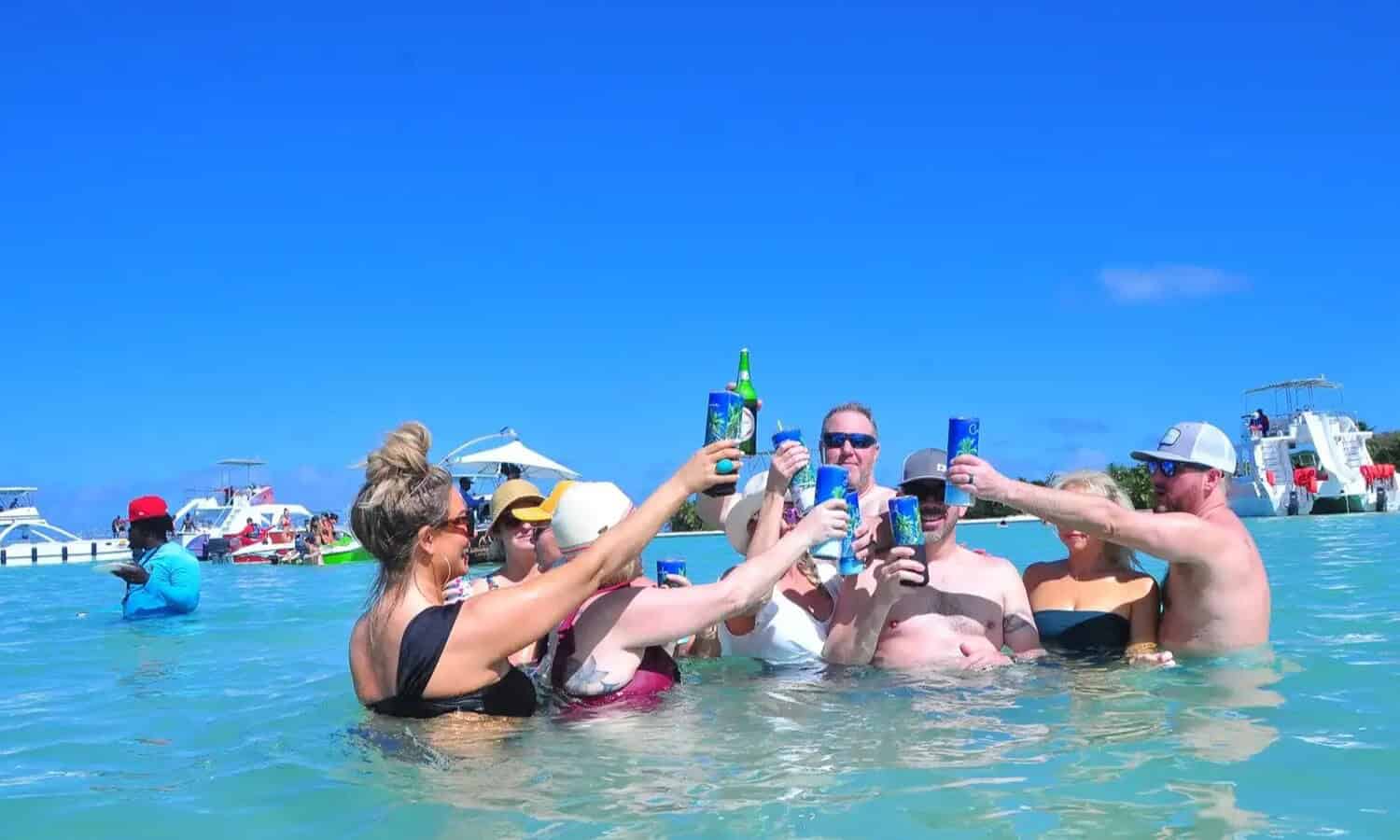 Punta Cana Group of friends raising drinks during a boat party in Punta Cana, Dominican Republic.