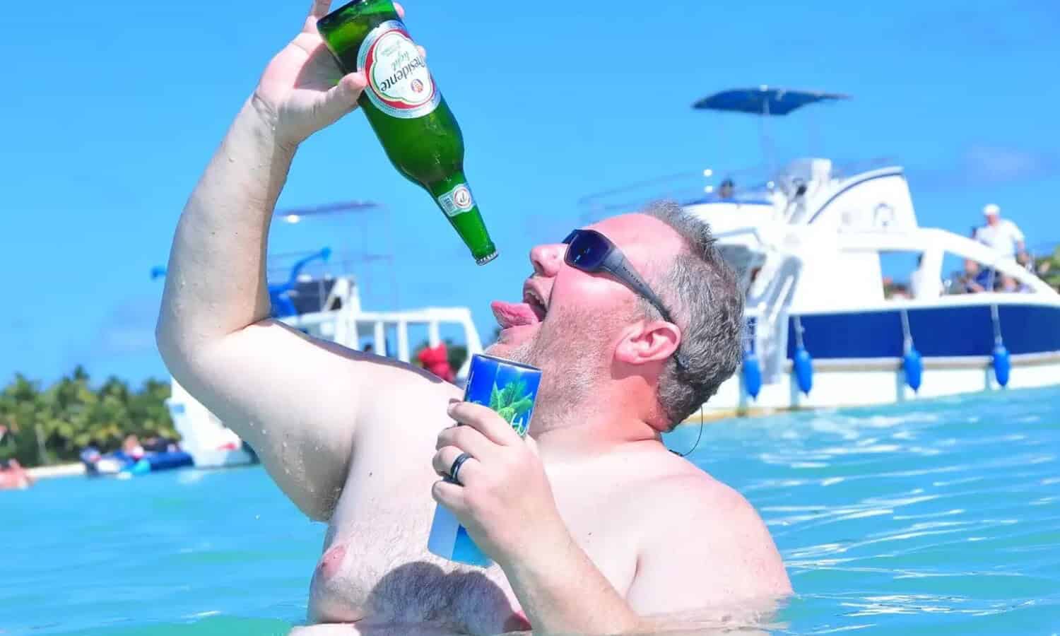 Punta Cana Man enjoying a cold beer on a boat during a Punta Cana excursion.
