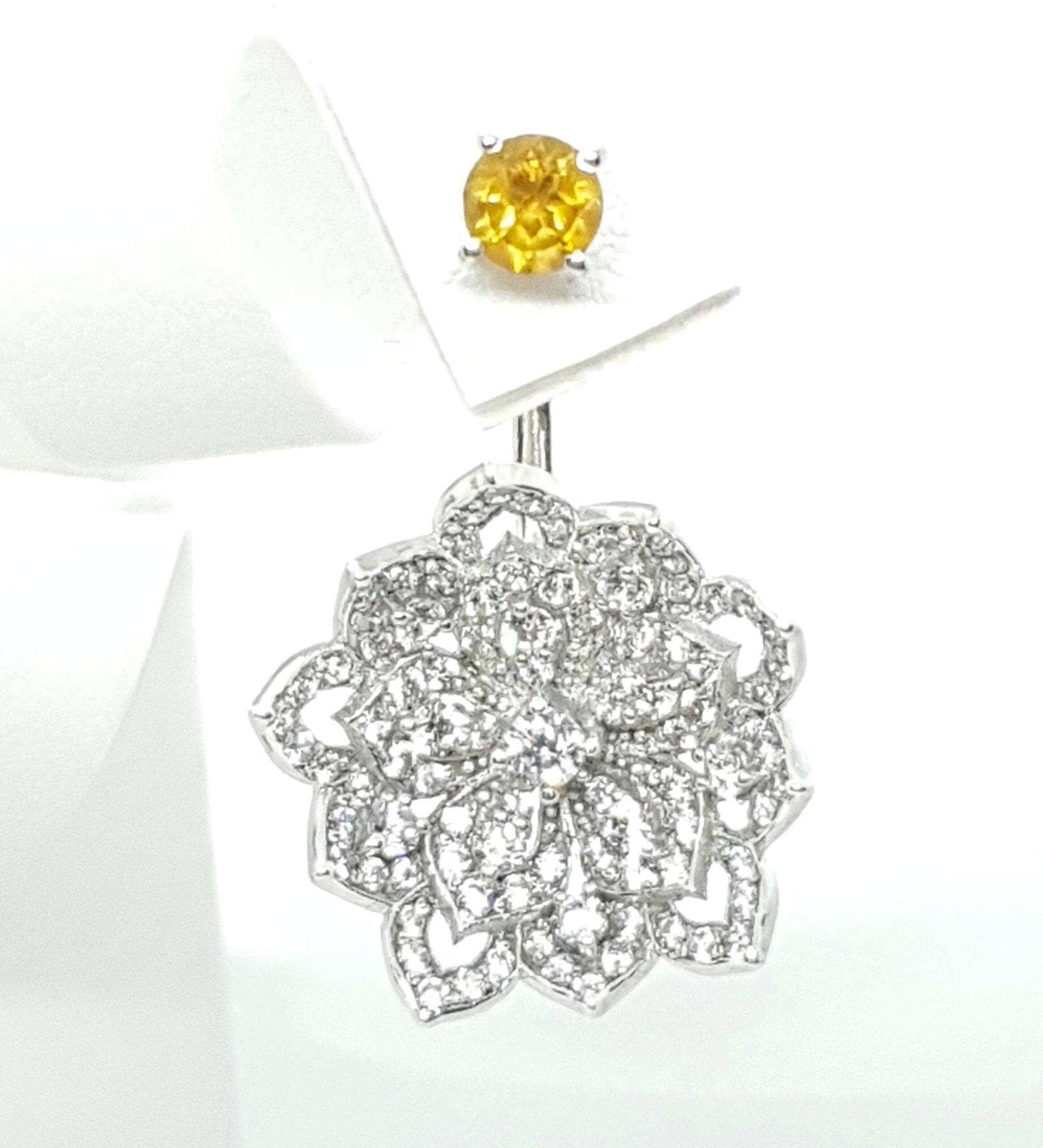Yellow gemstone stud earring with delicate silver flower pendant jewelry.