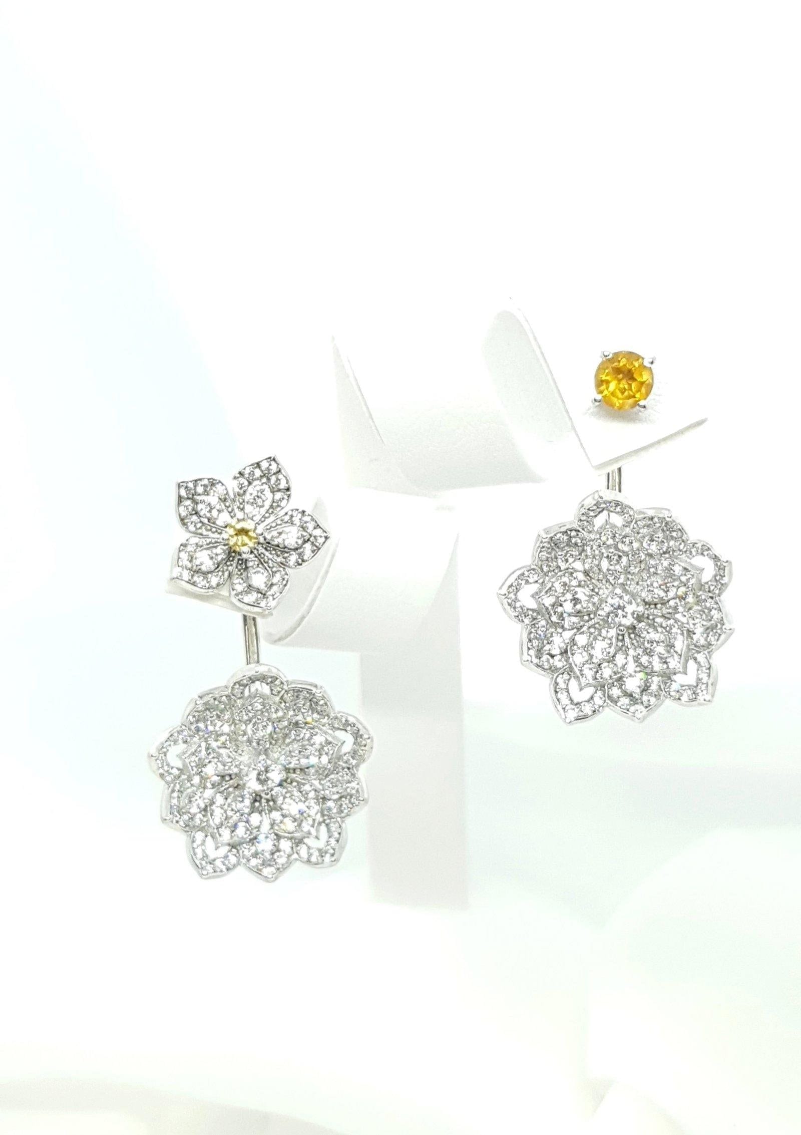 Dazzling floral-shaped diamond and gold earrings with intricate detailing.