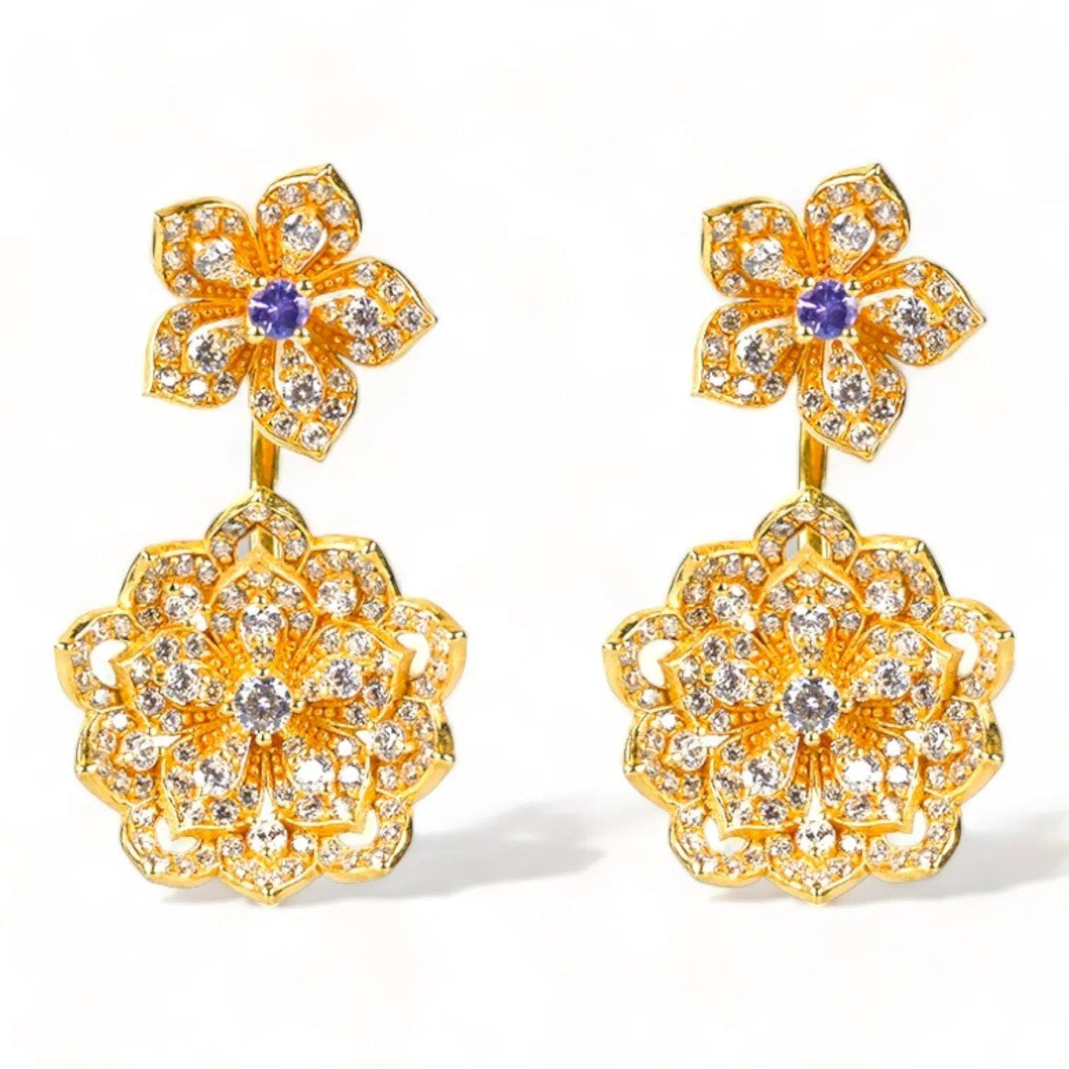 Delicate gold floral earrings with sparkling diamonds and purple gemstone accents.