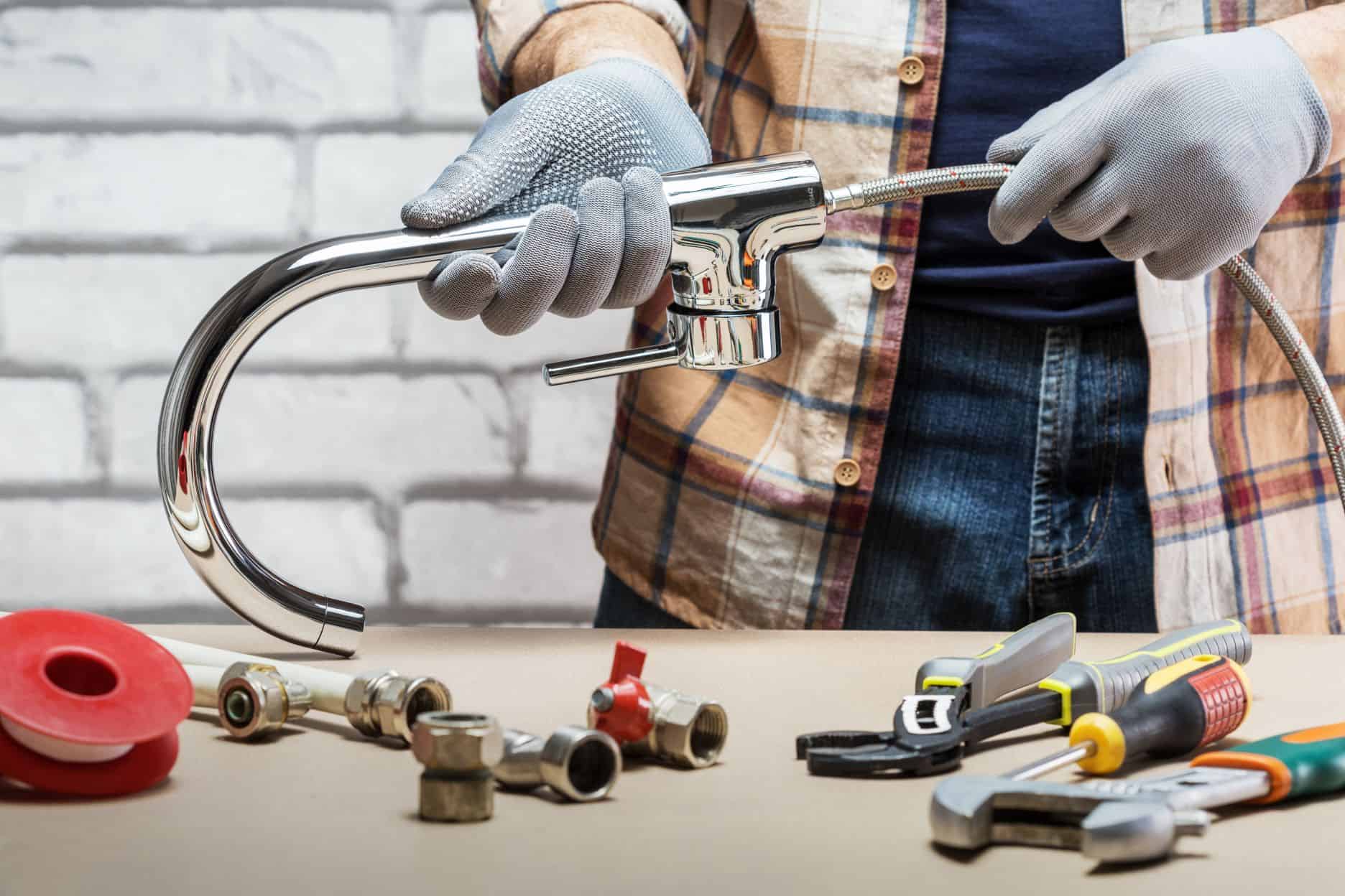 Plumber fixing a faucet