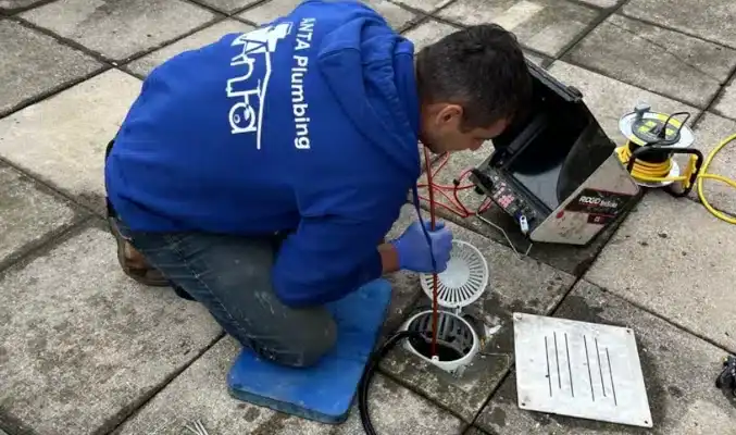 Plumber conducting drain inspection